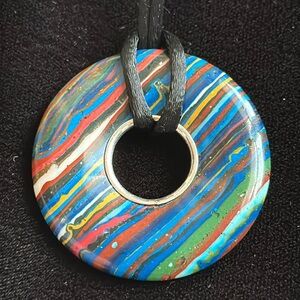 Genuine EUC calsilica pendant. Measures 1-3/4”. Includes black tie cord